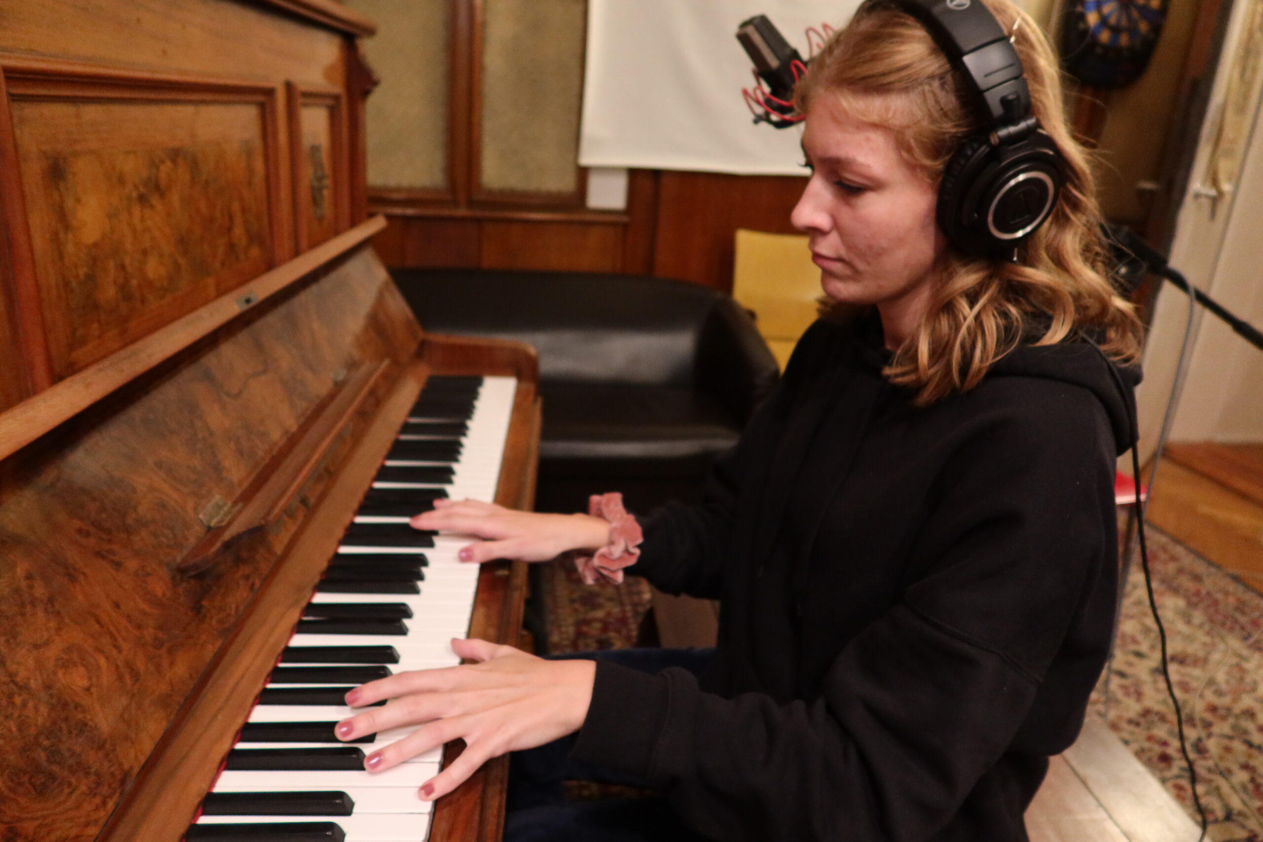 A youth worker playing piano at a Songs For Change workshop training. 