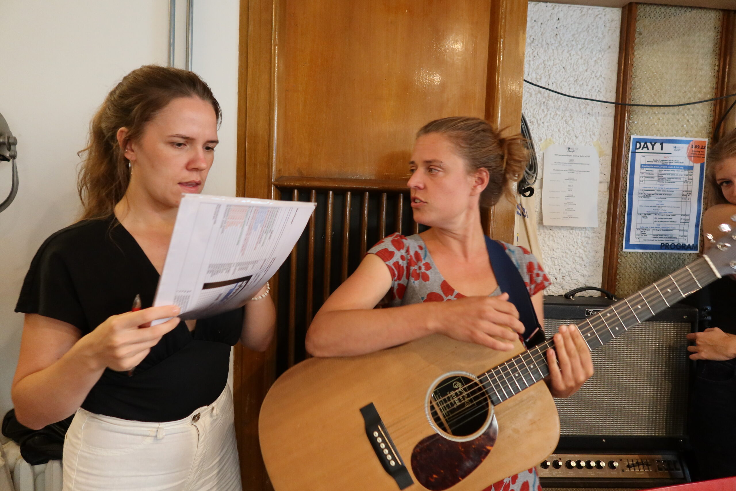 Youth leader and musician with guitar composing a song about EU Values at a Songs For Change workshop training. 